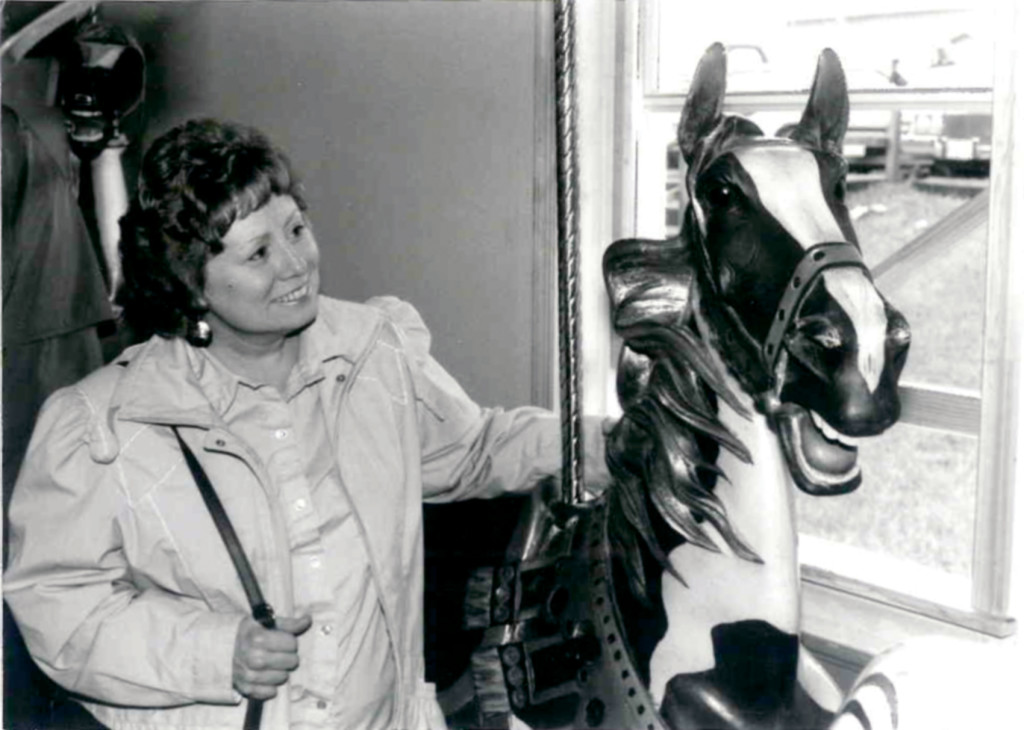 Carousel News & Trader Founding Editor, Nancy Lynn Loucks admires an Illions horse on a visit to Rol and Jo Summit.