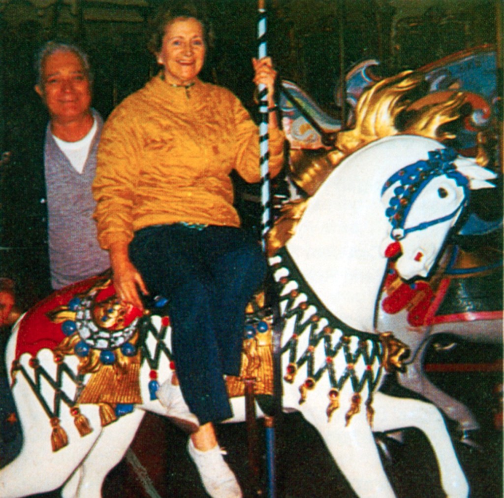Joe and Nelle DeLorenzo on the Illions Supreme at Bertrand Island in the late 1960s. Joe painted the horse. The Supreme Monarch II was built between 1921-1925 for the $2 million Amusement Department Store on Surf Ave., where it opened in 1926. In 1935, the supreme was sold for $7,200 and the exchange of a smaller carousel. The new owner brought the ride to Bertrand Island Amusement Park in NJ. Ownership of the carousel transferred through the family, finally to Joe and Nette DeLorenzo in the early 1960s. When the park went to one-price admission in 1972 the carousel was taking a beating. Joe and Nette sold the ride to Ringling Bros. for their new Circus World park in Orlando. Circus World changed hands in the mid-‘70s and again in 1984. In 1985, the Circus World carousel went to auction and sold intact for $437,800 to a NY developer who planned to install it. But, the carousel was at auction again in 1987 with a reserve of $825,000. It did not sell and was later sold to a private collector. The figures went to auction in 1988. The mechanism went to John Daniel and is now owned by George Schott who is repopulating the machine. (CNT 4-88) 