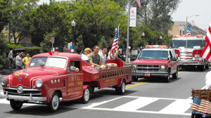 Dan displays his newly acquired Idora Park kiddie fire truck in the South Pasadena 4th of July parade. He tried to be in the parade every year, but would not drive the same truck twice.