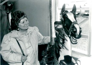 Nancy Loucks, CN&T founder, admires a beautifully restored Illions at the home of Rol and Jo Summit in Rolling Hills, CA, during a visit in the late 1980s.